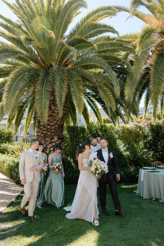 Bridal party dressed in coastal tones celebrating at a Northern California waterfront wedding