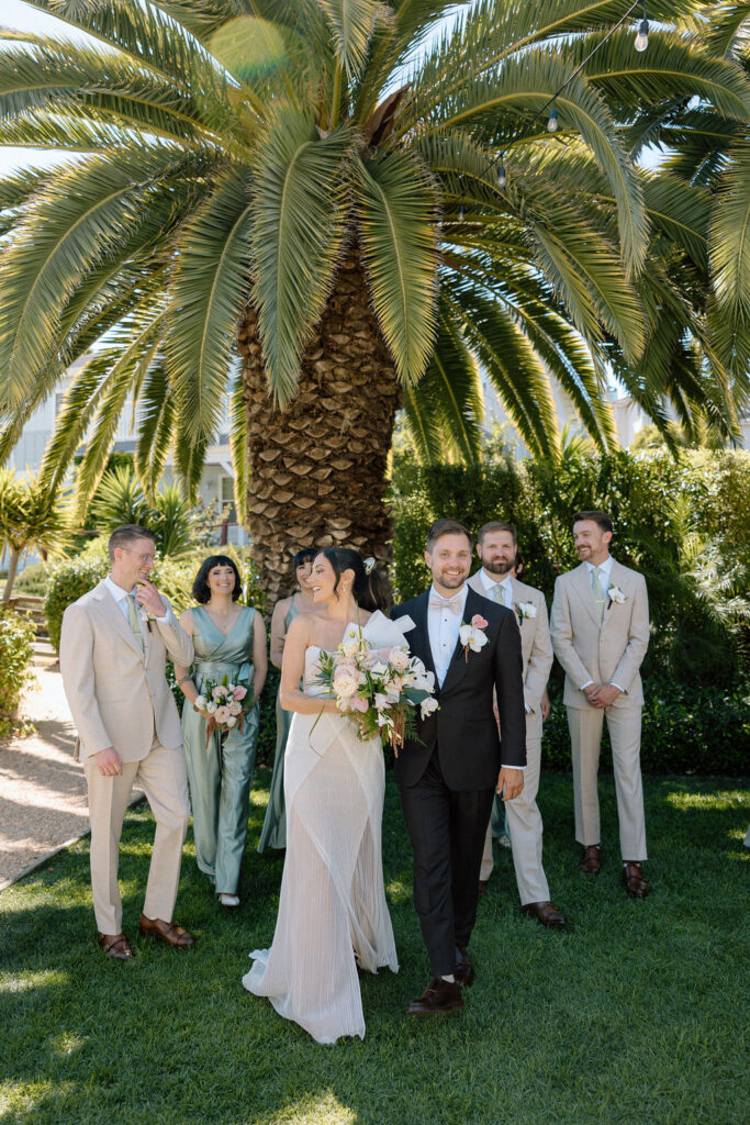Bridal party dressed in coastal tones celebrating at a Northern California waterfront wedding