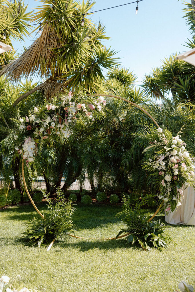 Bride and groom exchanging vows during an outdoor ceremony at Glen Cove Marina, surrounded by palm trees and sailboats in Northern California