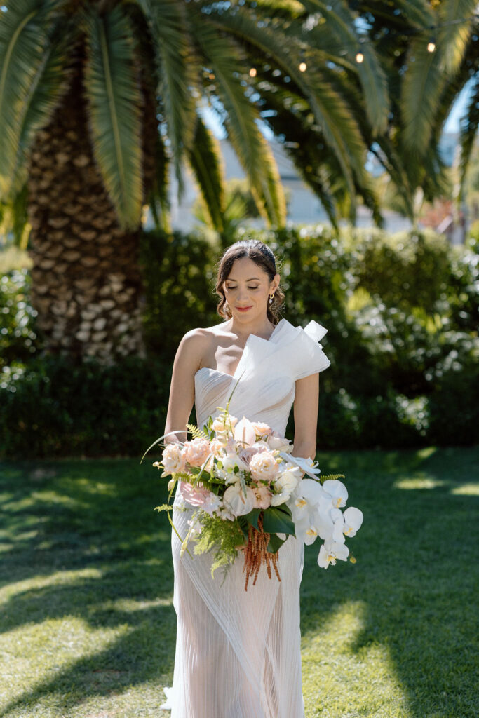 Bride getting ready with natural light pouring into the room before her Northern California sailboat wedding