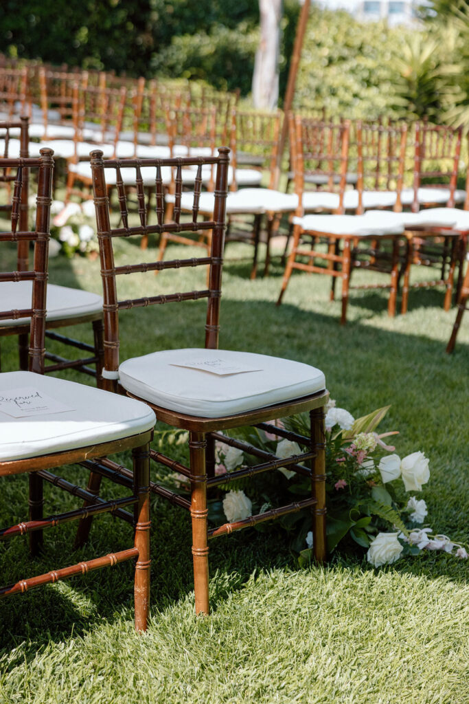 Bride and groom exchanging vows during an outdoor ceremony at Glen Cove Marina, surrounded by palm trees and sailboats in Northern California