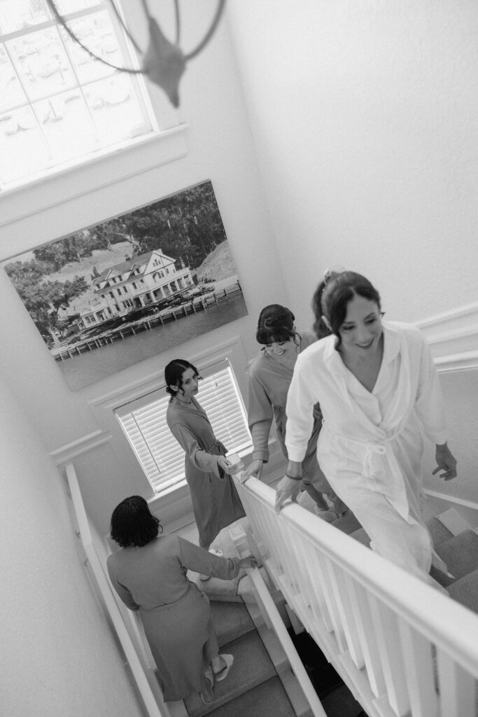 Bride getting ready with natural light pouring into the room before her Northern California sailboat wedding
