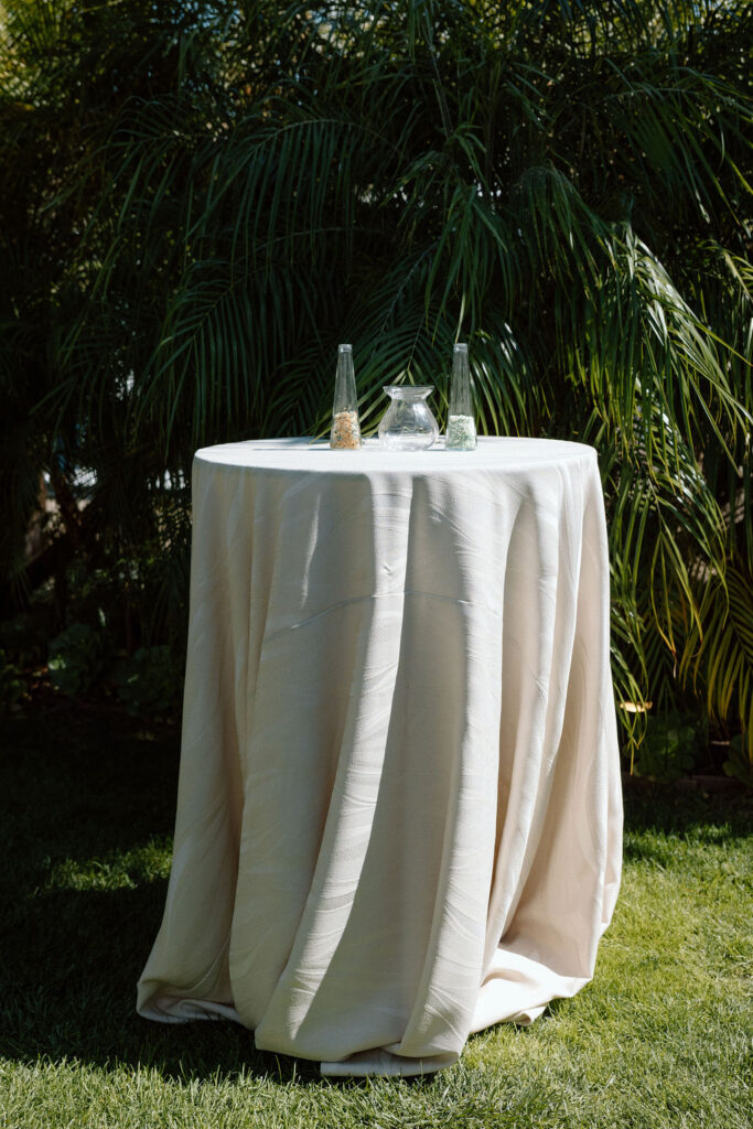 Bride and groom exchanging vows during an outdoor ceremony at Glen Cove Marina, surrounded by palm trees and sailboats in Northern California