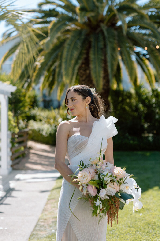 Bride getting ready with natural light pouring into the room before her Northern California sailboat wedding