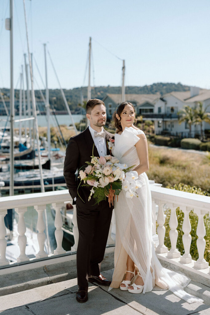 Bride and groom sharing their first look on a balcony overlooking sailboats at Glen Cove Marina