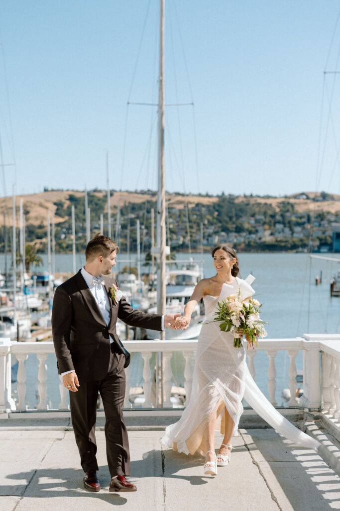 Bride and groom sharing their first look on a balcony overlooking sailboats at Glen Cove Marina