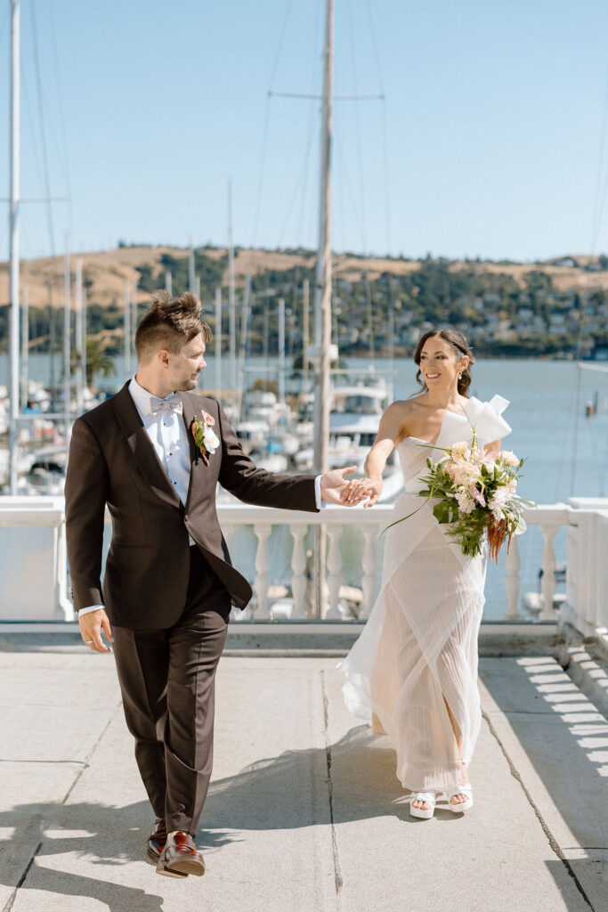 Bride and groom sharing their first look on a balcony overlooking sailboats at Glen Cove Marina
