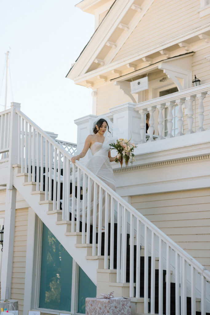 Bride and groom exchanging vows during an outdoor ceremony at Glen Cove Marina, surrounded by palm trees and sailboats in Northern California