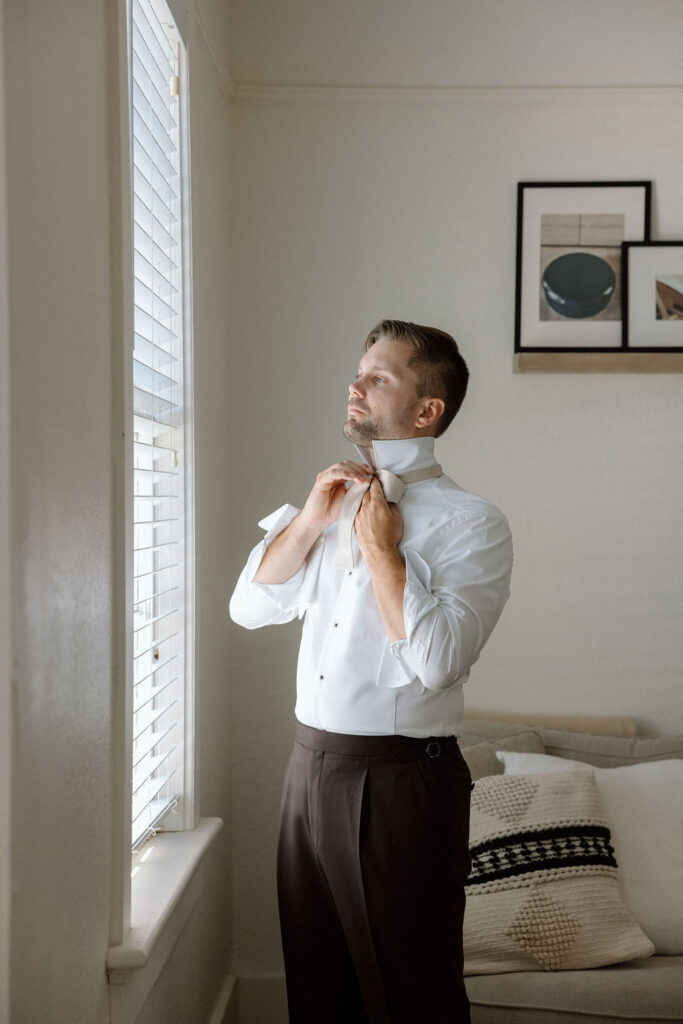 Groom preparing for his wedding day before the ceremony at a San Francisco Bay sailboat wedding