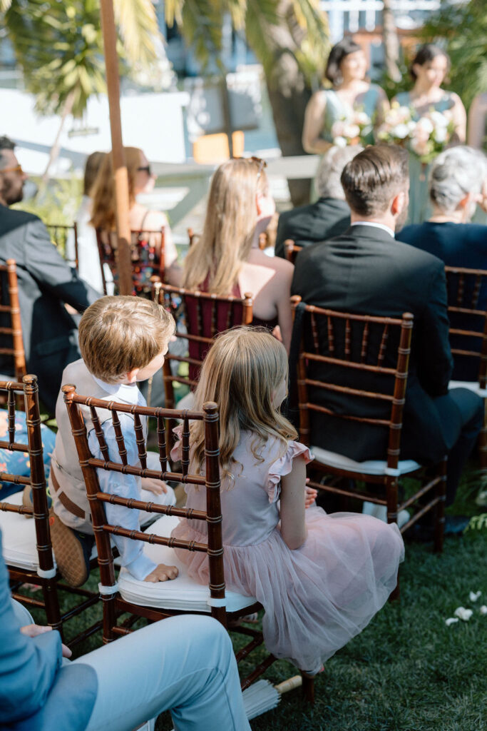 Bride and groom exchanging vows during an outdoor ceremony at Glen Cove Marina, surrounded by palm trees and sailboats in Northern California