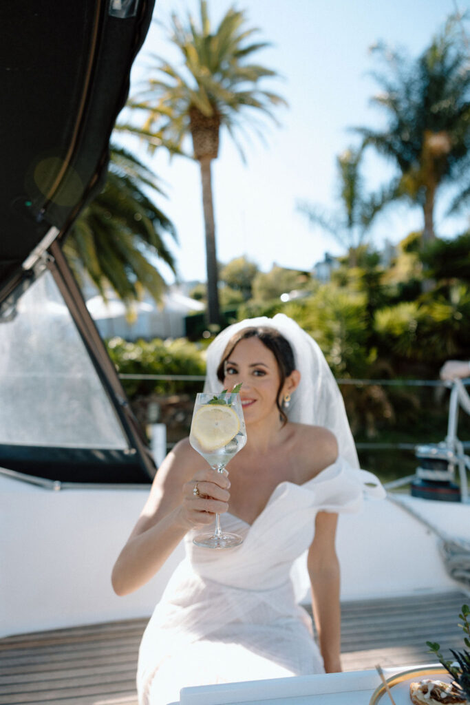 Newly married couple walking hand-in-hand from their ceremony to a sailboat dock at a Northern California marina wedding