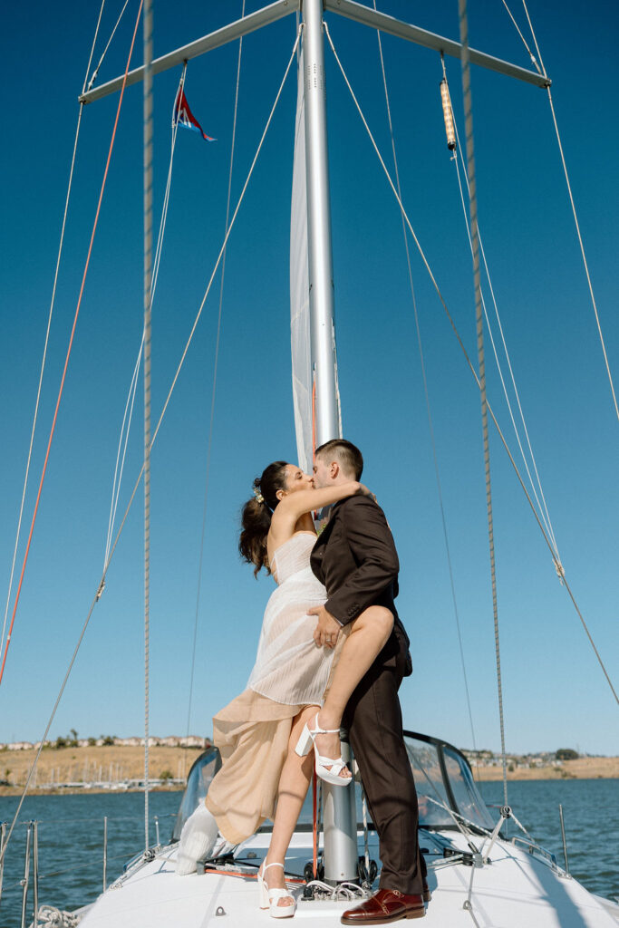 Bride wearing a flowing wedding gown in ocean breeze during a Northern California sailboat wedding