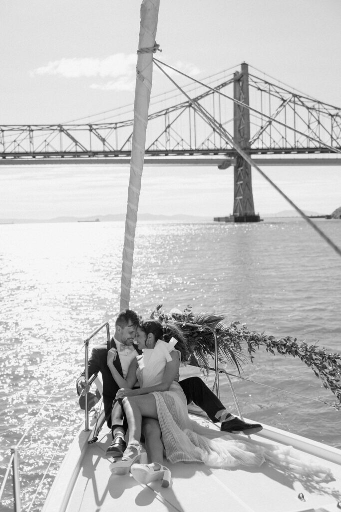 Bride wearing a flowing wedding gown in ocean breeze during a Northern California sailboat wedding