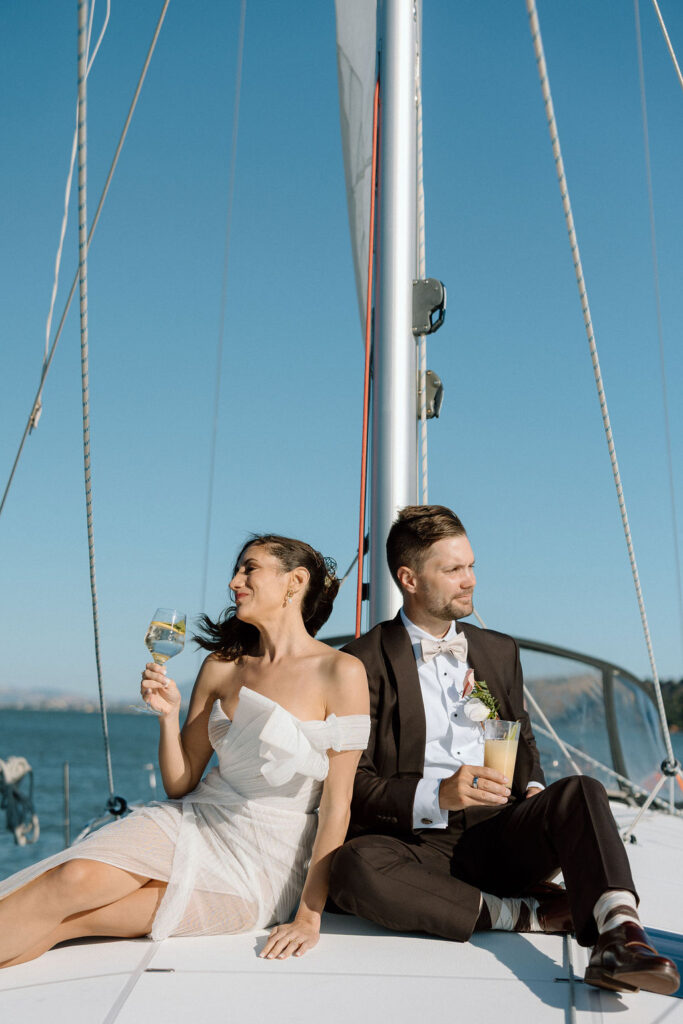 Bride wearing a flowing wedding gown in ocean breeze during a Northern California sailboat wedding