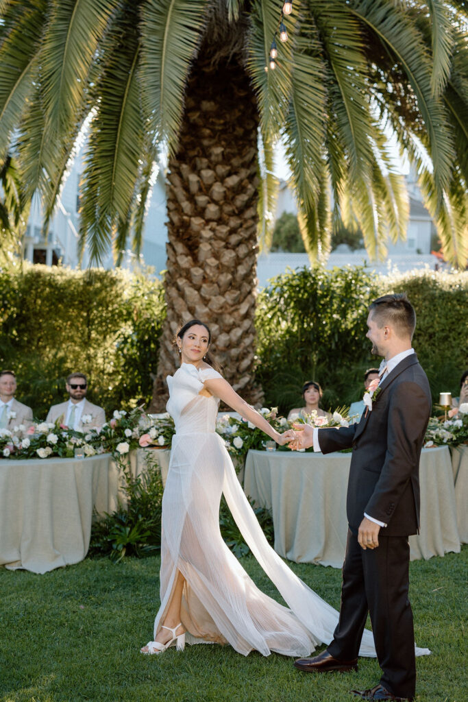 Golden hour reception beneath palm trees at a Northern California waterfront wedding