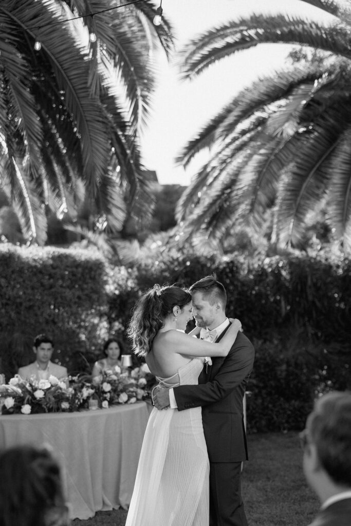 Golden hour reception beneath palm trees at a Northern California waterfront wedding