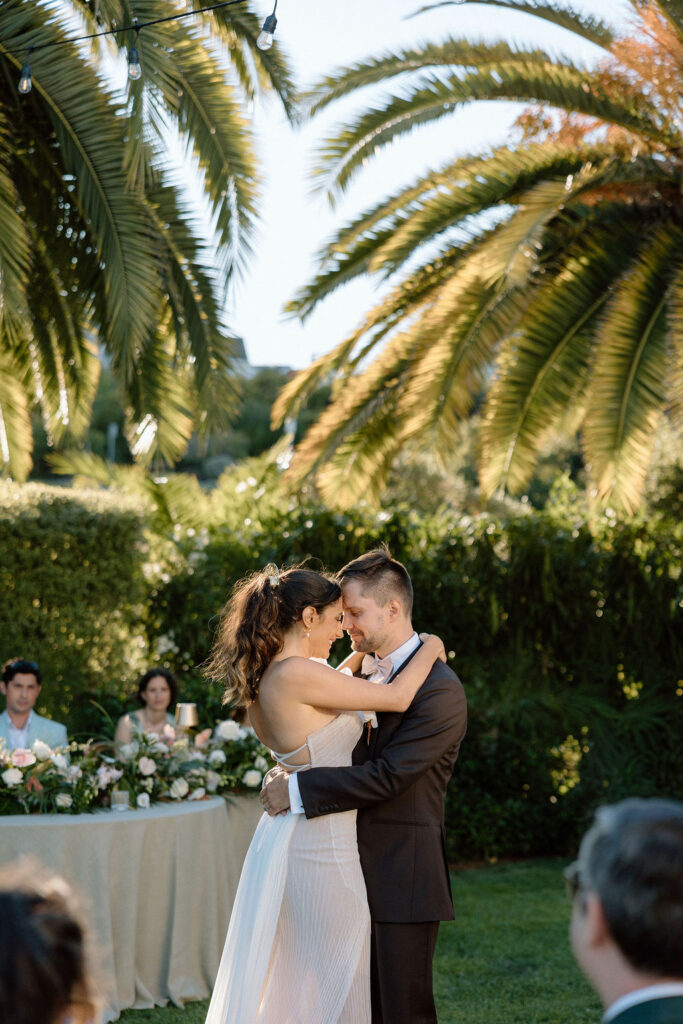 Golden hour reception beneath palm trees at a Northern California waterfront wedding