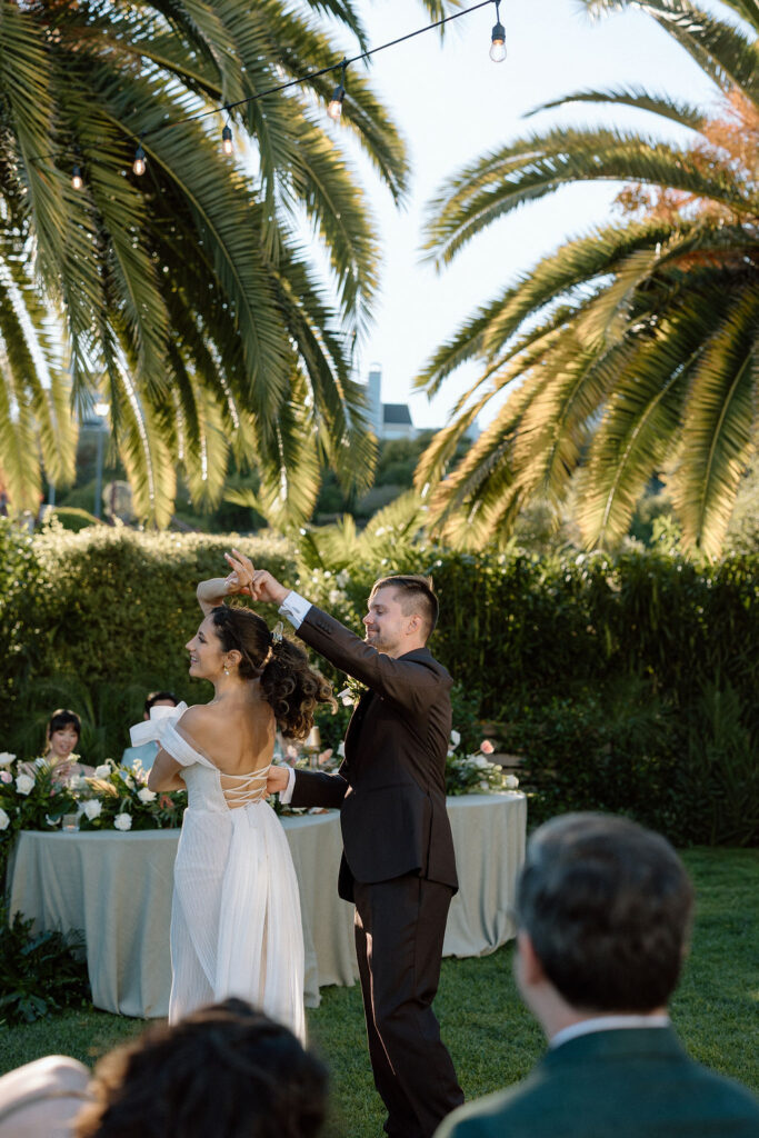 Golden hour reception beneath palm trees at a Northern California waterfront wedding