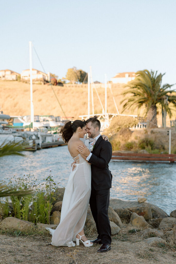 Romantic newlywed portraits overlooking the harbor at a Northern California sailboat wedding