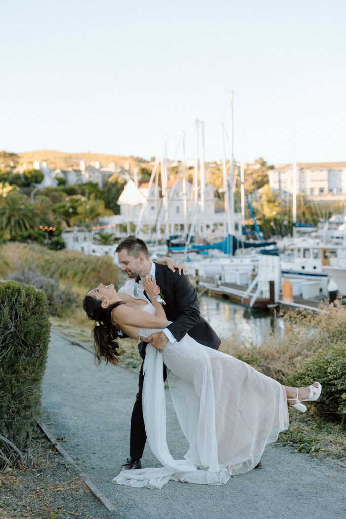 Romantic newlywed portraits overlooking the harbor at a Northern California sailboat wedding