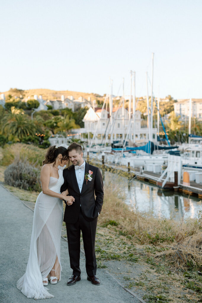 Romantic newlywed portraits overlooking the harbor at a Northern California sailboat wedding