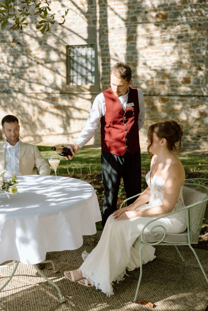 Private wine and hors d’oeuvres celebration in a secluded garden patio at Villa di Piazzano during a destination wedding weekend.