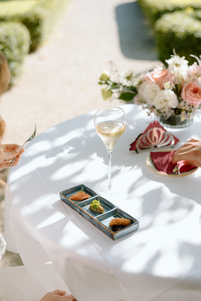 Private wine and hors d’oeuvres celebration in a secluded garden patio at Villa di Piazzano during a destination wedding weekend.
