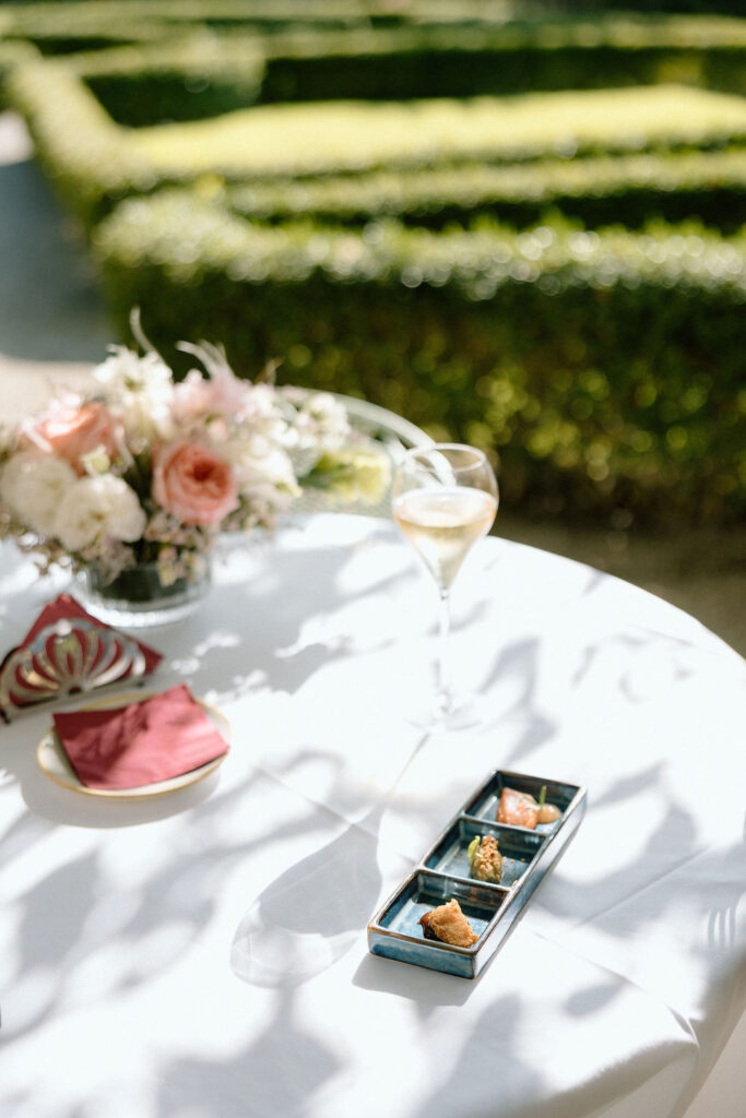 Private wine and hors d’oeuvres celebration in a secluded garden patio at Villa di Piazzano during a destination wedding weekend.