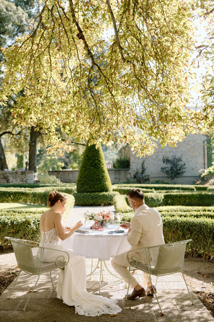Private wine and hors d’oeuvres celebration in a secluded garden patio at Villa di Piazzano during a destination wedding weekend.