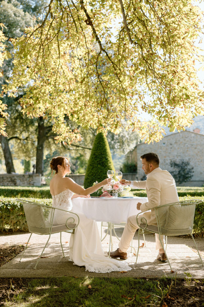 Private wine and hors d’oeuvres celebration in a secluded garden patio at Villa di Piazzano during a destination wedding weekend.