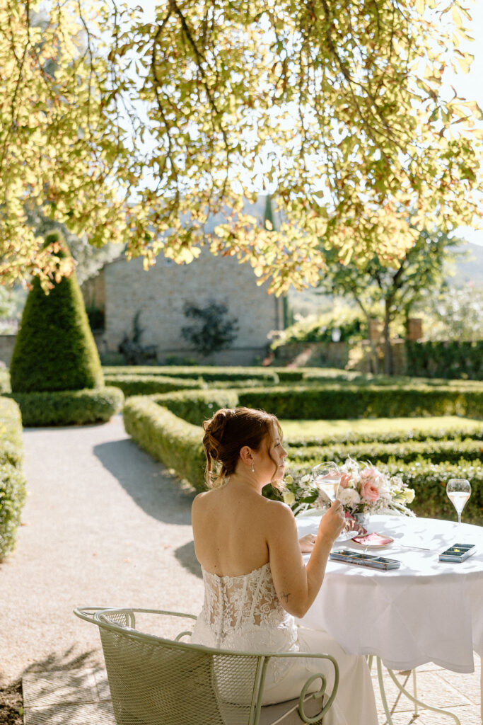 Private wine and hors d’oeuvres celebration in a secluded garden patio at Villa di Piazzano during a destination wedding weekend.