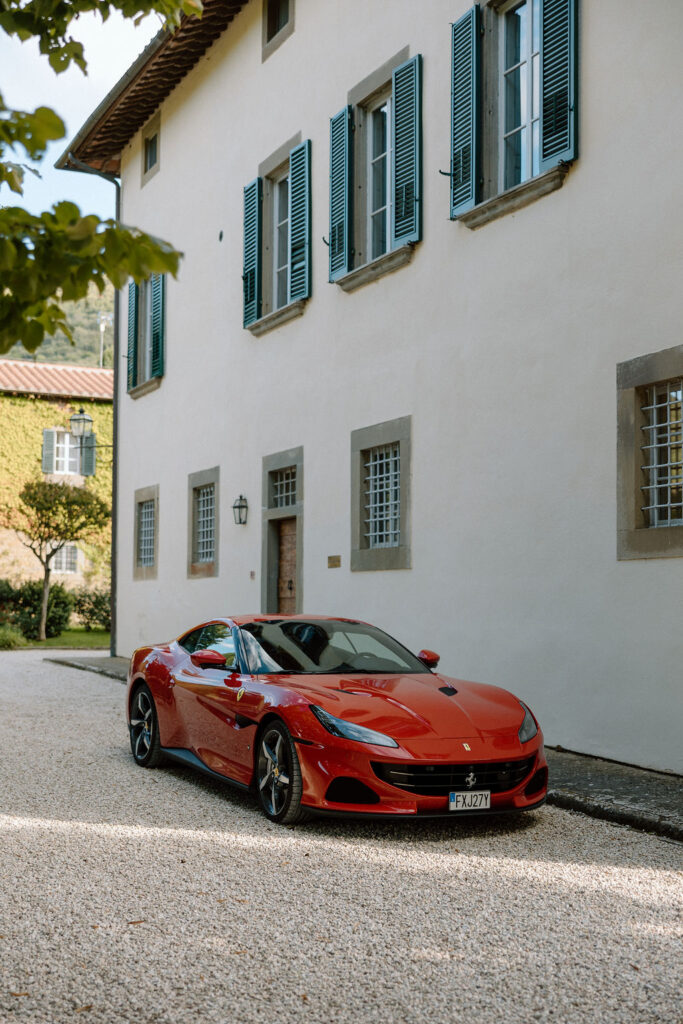 Bride and groom walking through the gardens of Villa di Piazzano in Tuscany, surrounded by cypress trees and rolling hills during an intimate destination wedding.
