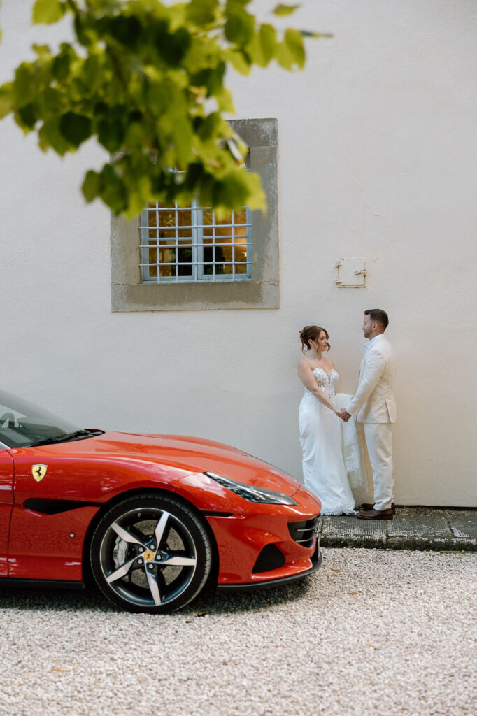 Bride and groom walking through the gardens of Villa di Piazzano in Tuscany, surrounded by cypress trees and rolling hills during an intimate destination wedding.
