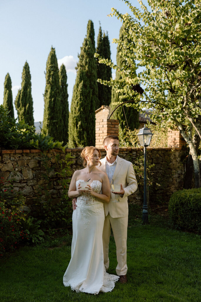 Private wine and hors d’oeuvres celebration in a secluded garden patio at Villa di Piazzano during a destination wedding weekend.