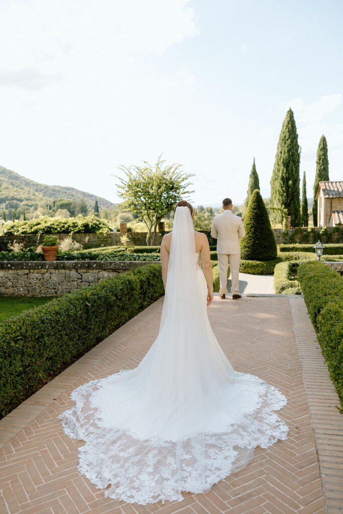 Emotional private vow exchange beneath olive trees at Villa di Piazzano during an intimate destination wedding in Italy.