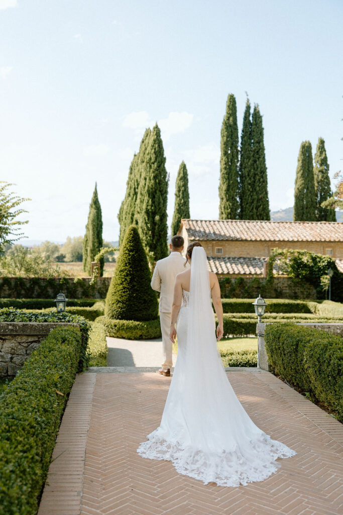 Emotional private vow exchange beneath olive trees at Villa di Piazzano during an intimate destination wedding in Italy.