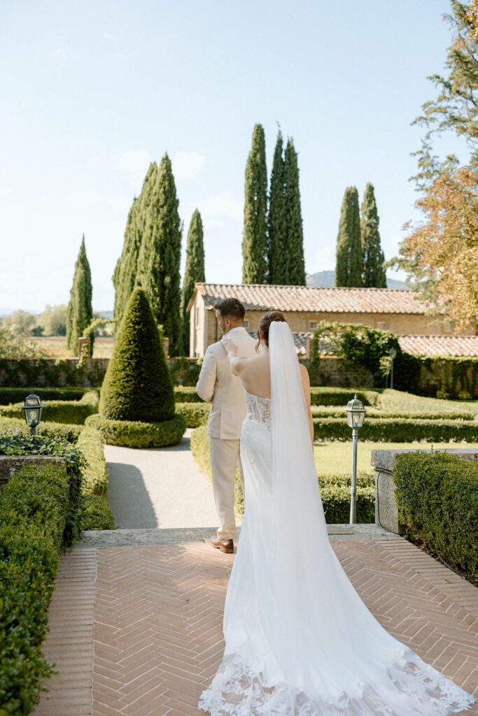 Emotional private vow exchange beneath olive trees at Villa di Piazzano during an intimate destination wedding in Italy.