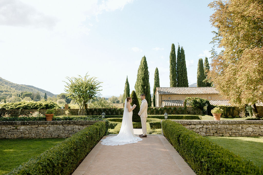 Emotional private vow exchange beneath olive trees at Villa di Piazzano during an intimate destination wedding in Italy.
