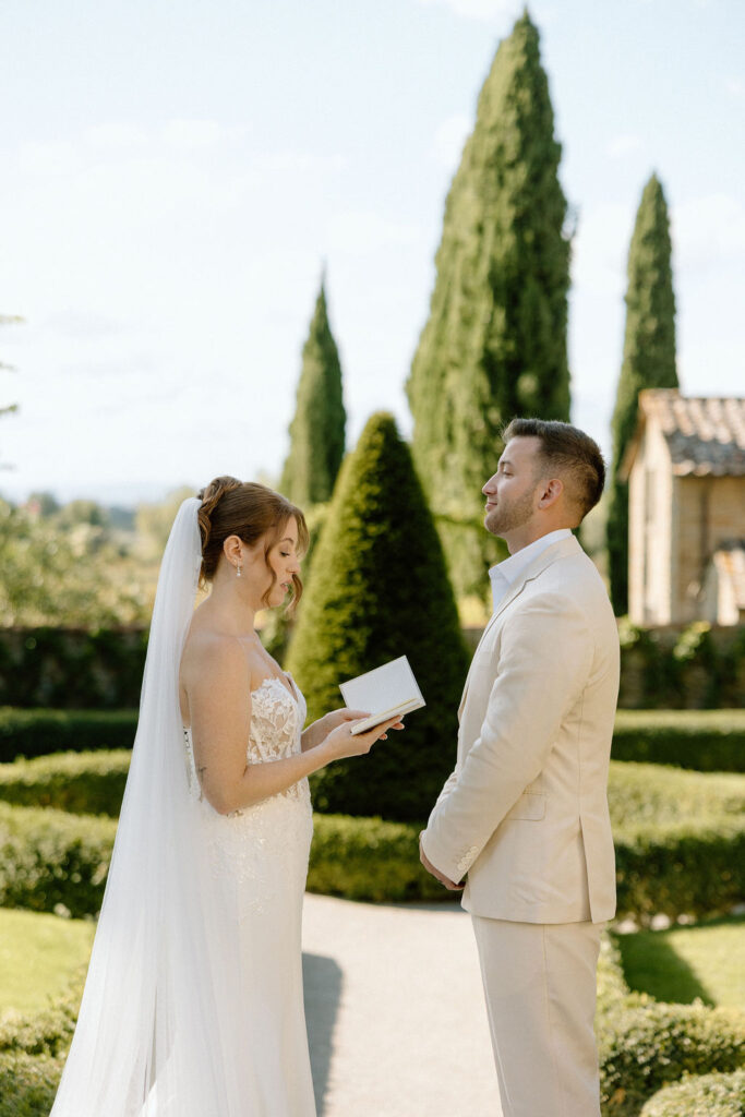 Emotional private vow exchange beneath olive trees at Villa di Piazzano during an intimate destination wedding in Italy.