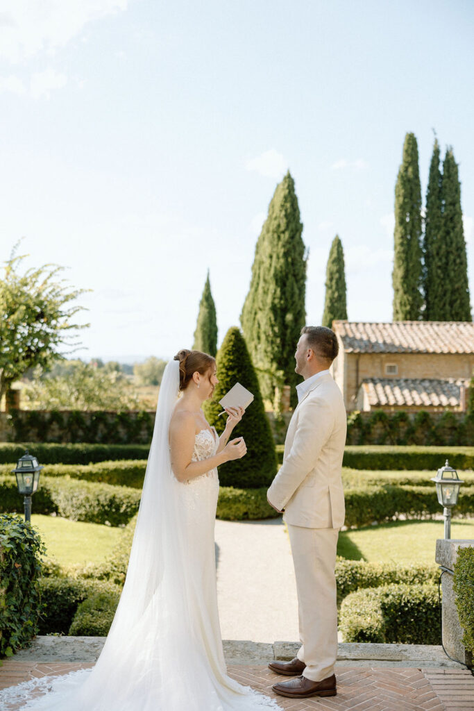 Emotional private vow exchange beneath olive trees at Villa di Piazzano during an intimate destination wedding in Italy.