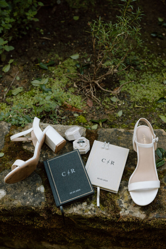 Bride wearing a lace wedding gown with corseted bodice and cathedral veil while getting ready in an antique-filled suite at Villa di Piazzano.
