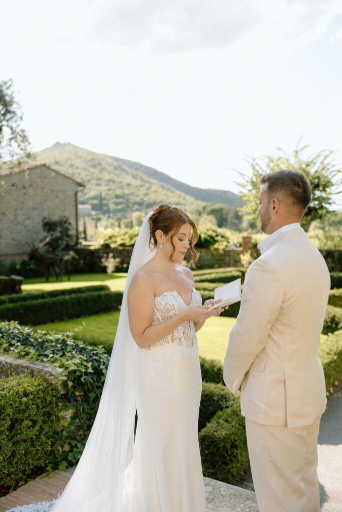 Emotional private vow exchange beneath olive trees at Villa di Piazzano during an intimate destination wedding in Italy.