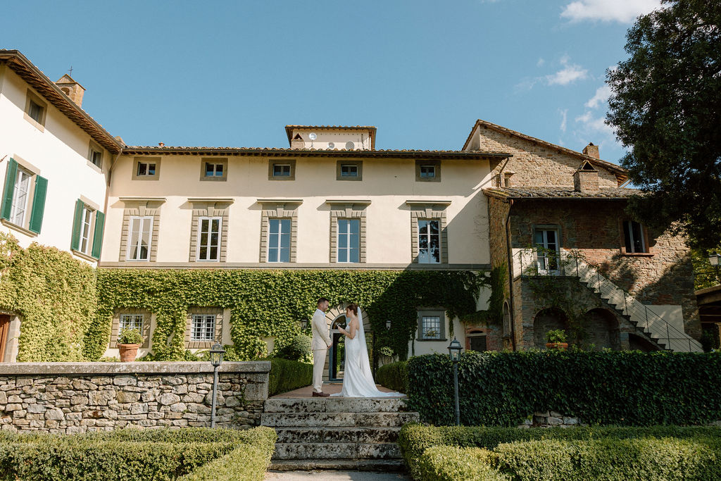 Emotional private vow exchange beneath olive trees at Villa di Piazzano during an intimate destination wedding in Italy.