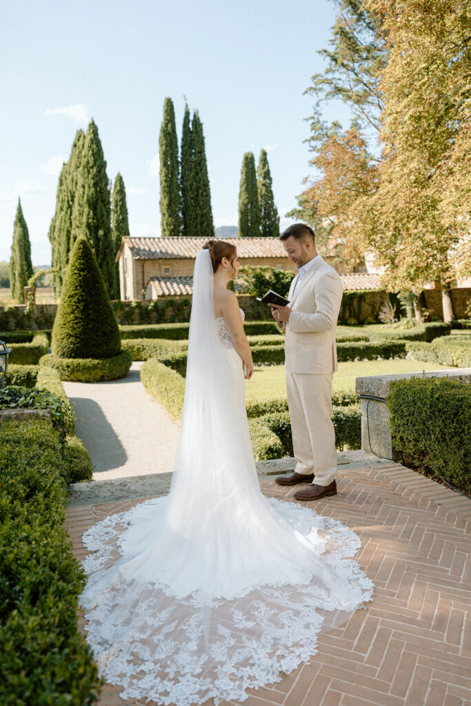 Emotional private vow exchange beneath olive trees at Villa di Piazzano during an intimate destination wedding in Italy.