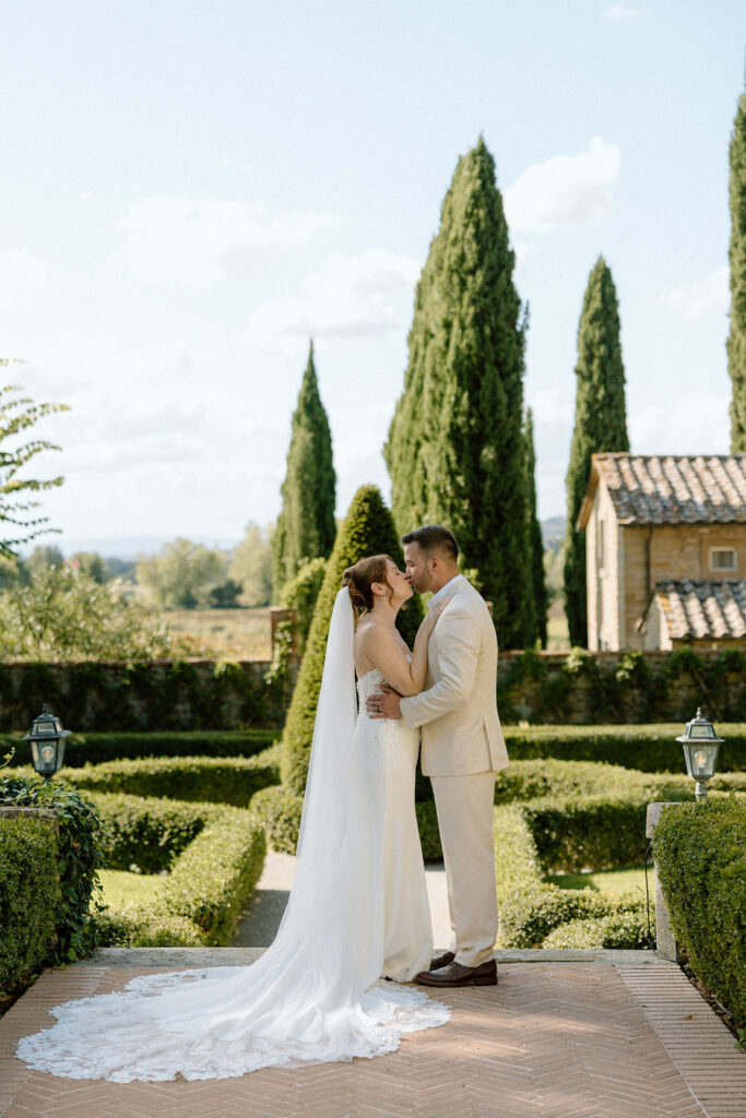 Emotional private vow exchange beneath olive trees at Villa di Piazzano during an intimate destination wedding in Italy.