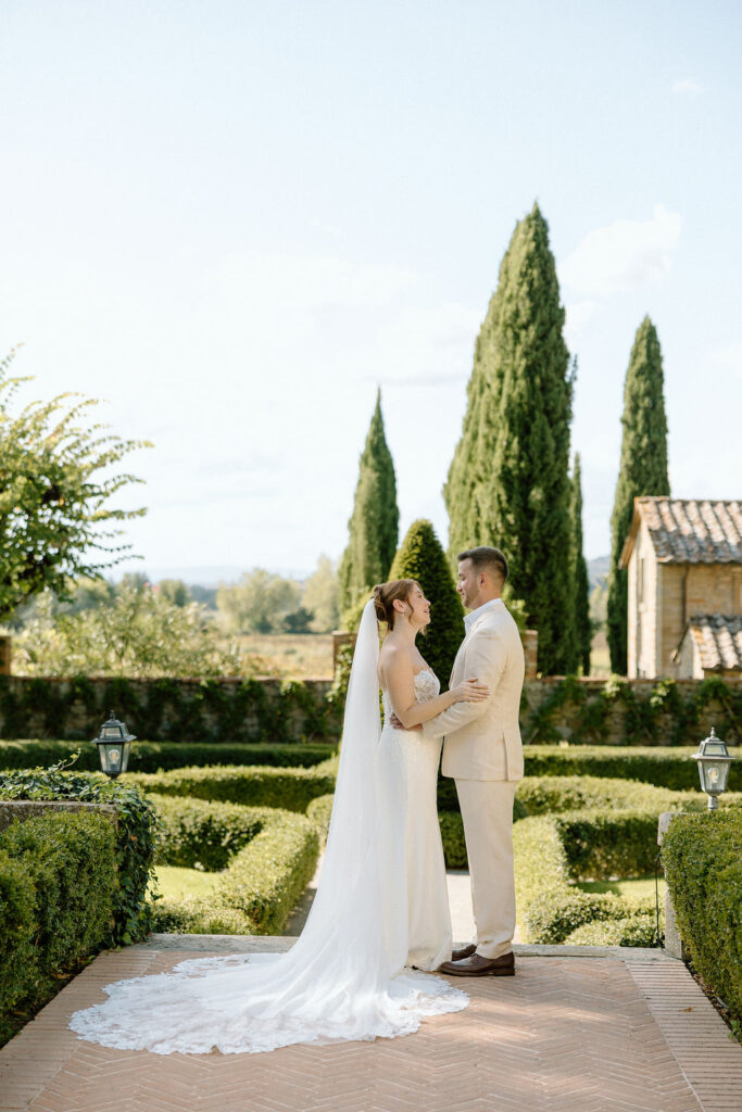 Emotional private vow exchange beneath olive trees at Villa di Piazzano during an intimate destination wedding in Italy.