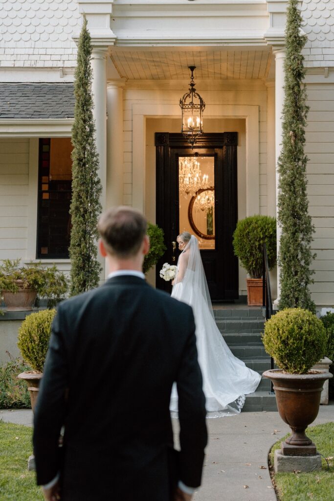 Bride and groom posing in front of Park Winters old victorian house 