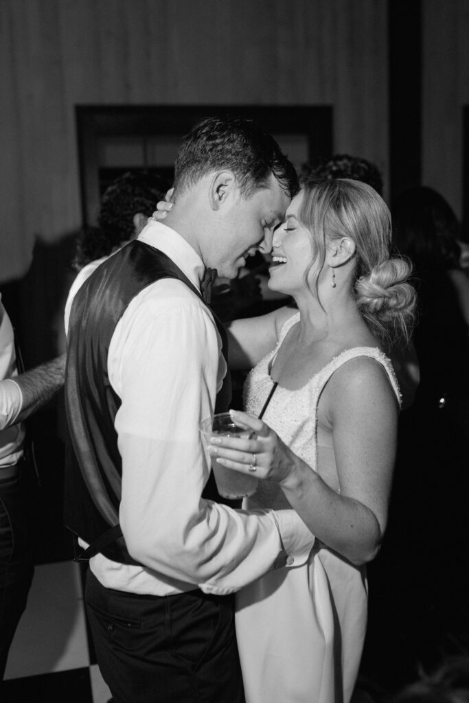 Bride and groom romantically dancing wedding reception party