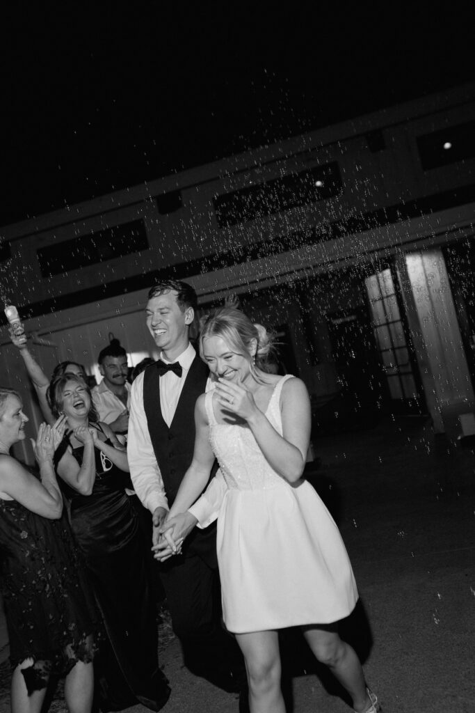 bride and groom exit their reception to a bubble exit on their wedding day at park winters california