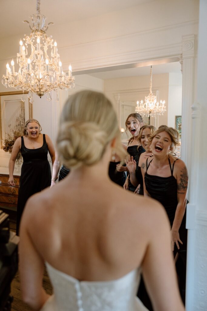 Bride reveals wedding dress to her bridesmaids on wedding day at Park Winters